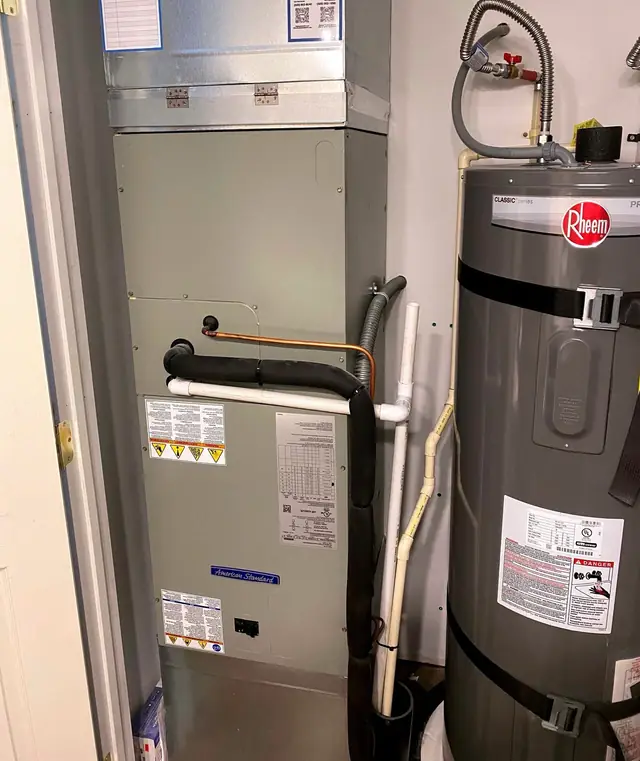 American Standard air handler beside a Rheem water heater